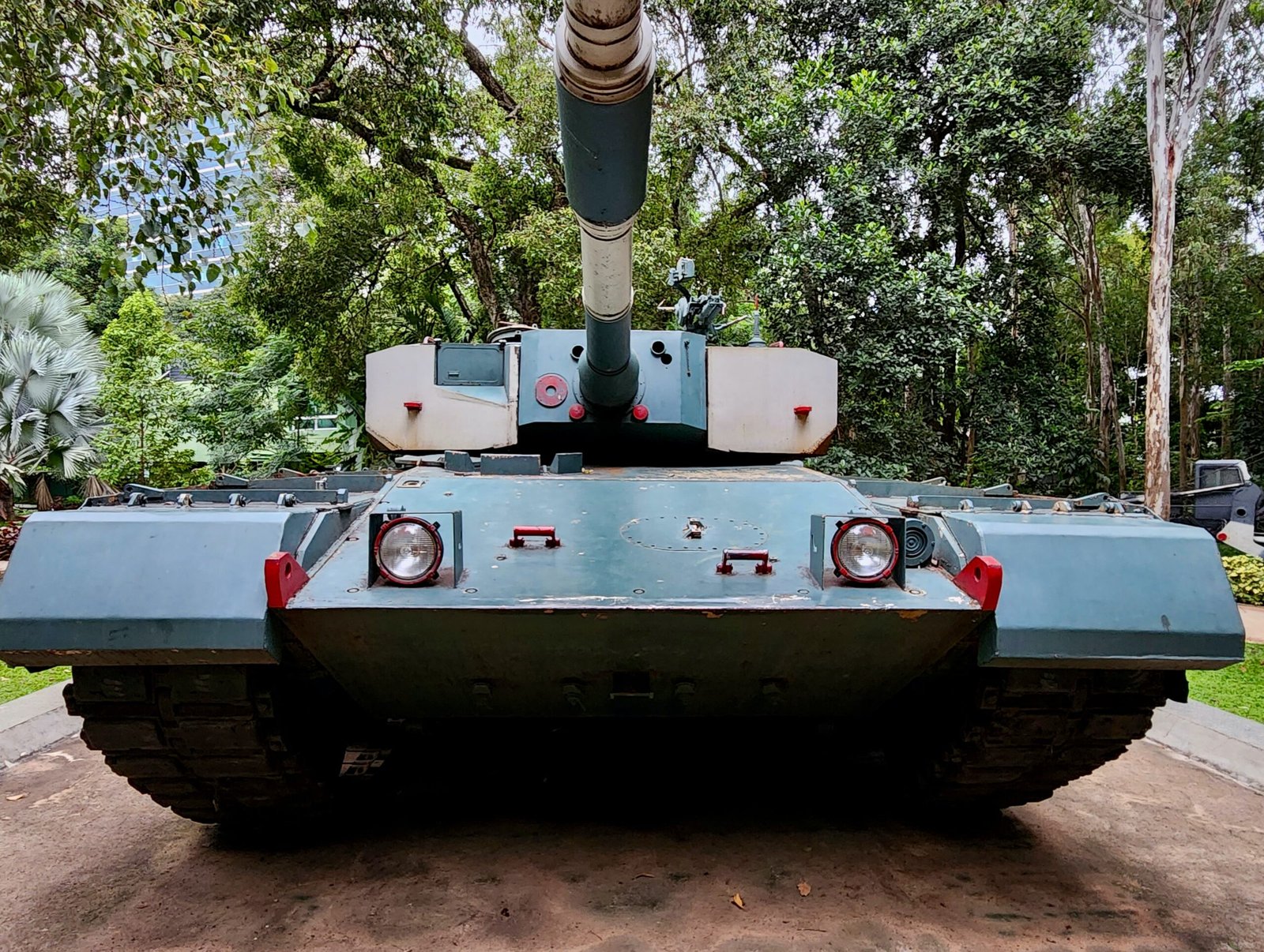 a military tank is parked in a park